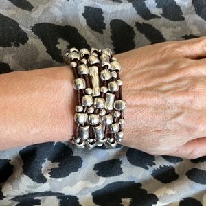 Uno de 50 6.5-7 inch small. Silver plated and brown cord. Magnetic closure.